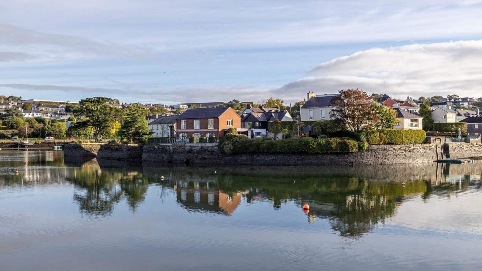Colourful waterfront buildings and boats beside the harbour in Kinsale, County Cork, Ireland.