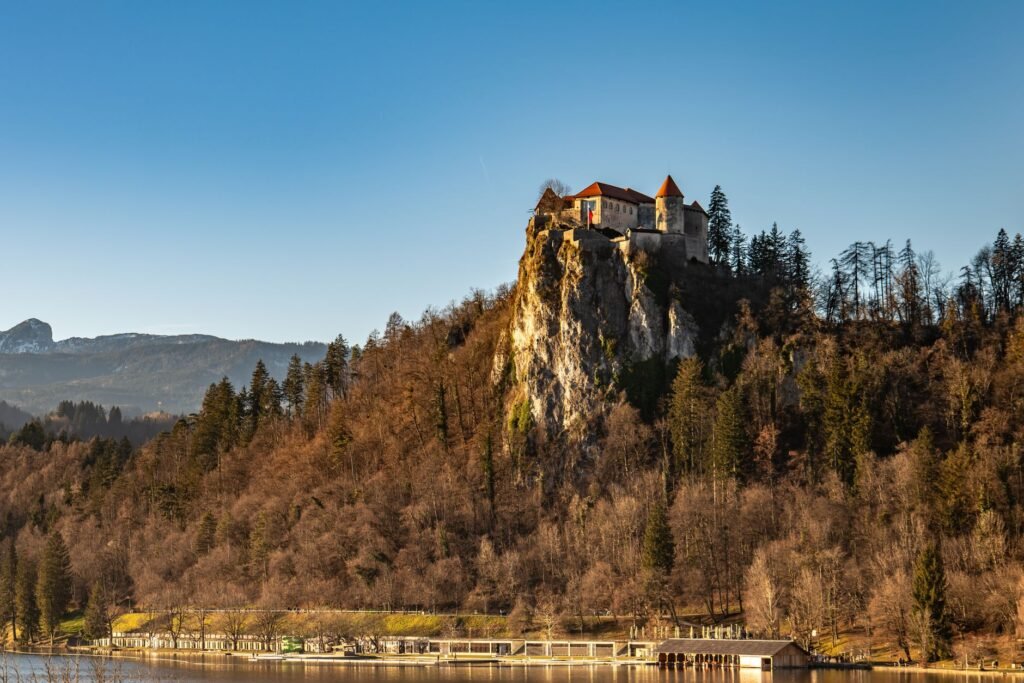 Bled Castle standing on a steep wooded cliff above Lake Bled in Slovenia.
